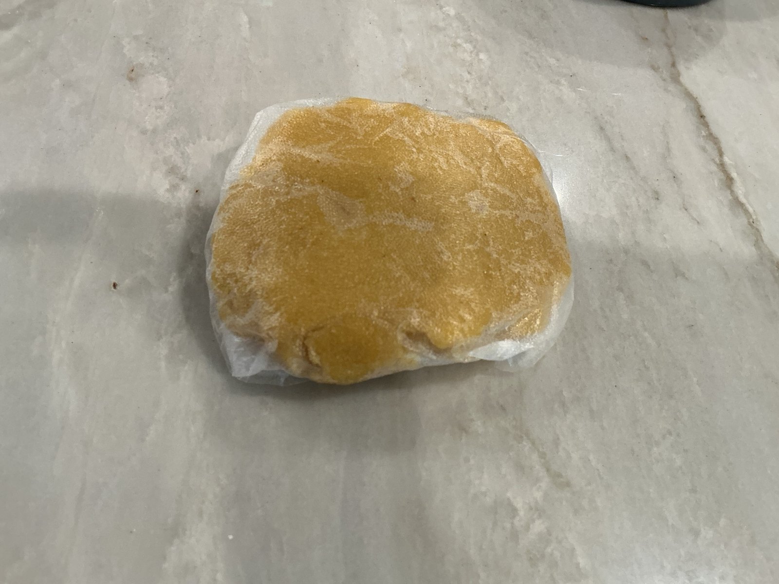 The almond flour dough wrapped in plastic, ready to chill